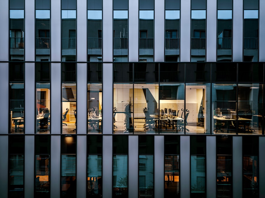 Fachada de oficinas con ventanas iluminadas al atardecer